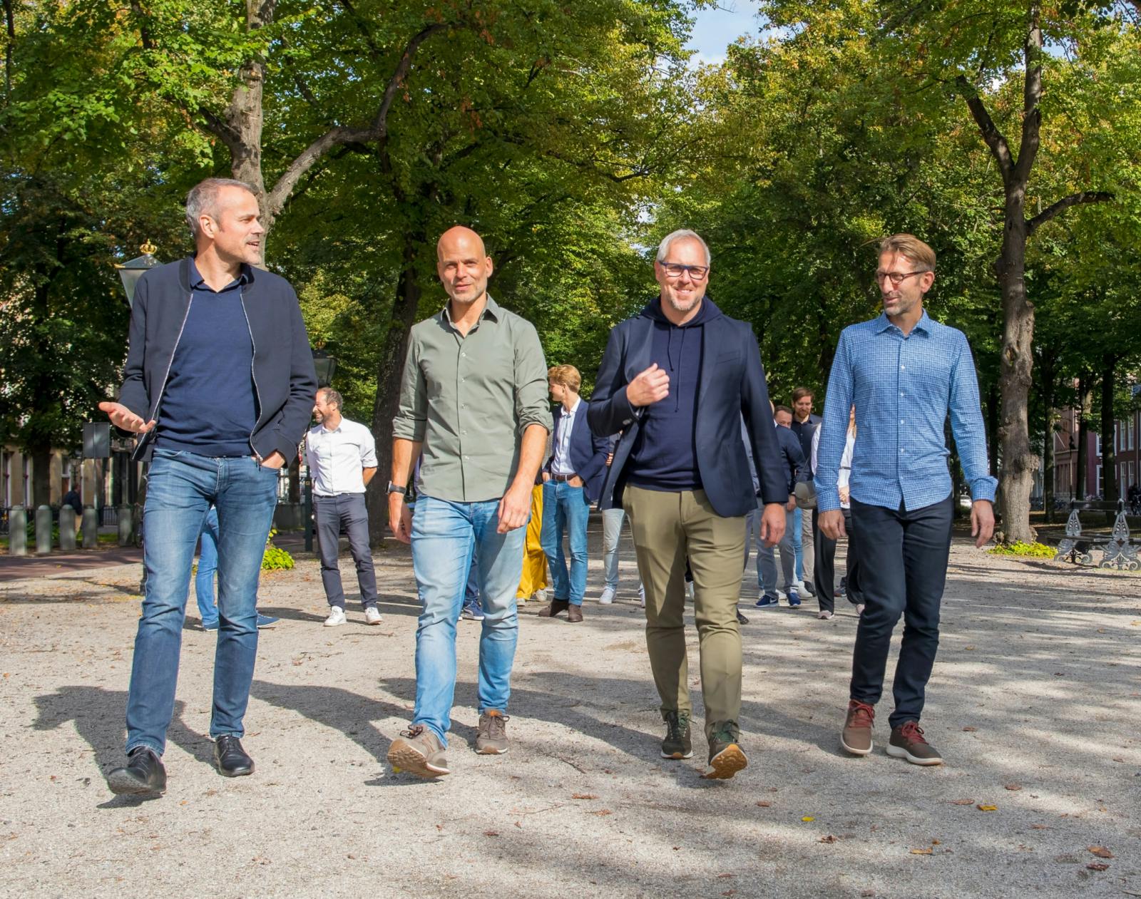 Gert Hans Berghuis, Stef Brooijmans, Mattias Olofsson, Matthijs Klinkert together walking in a park.