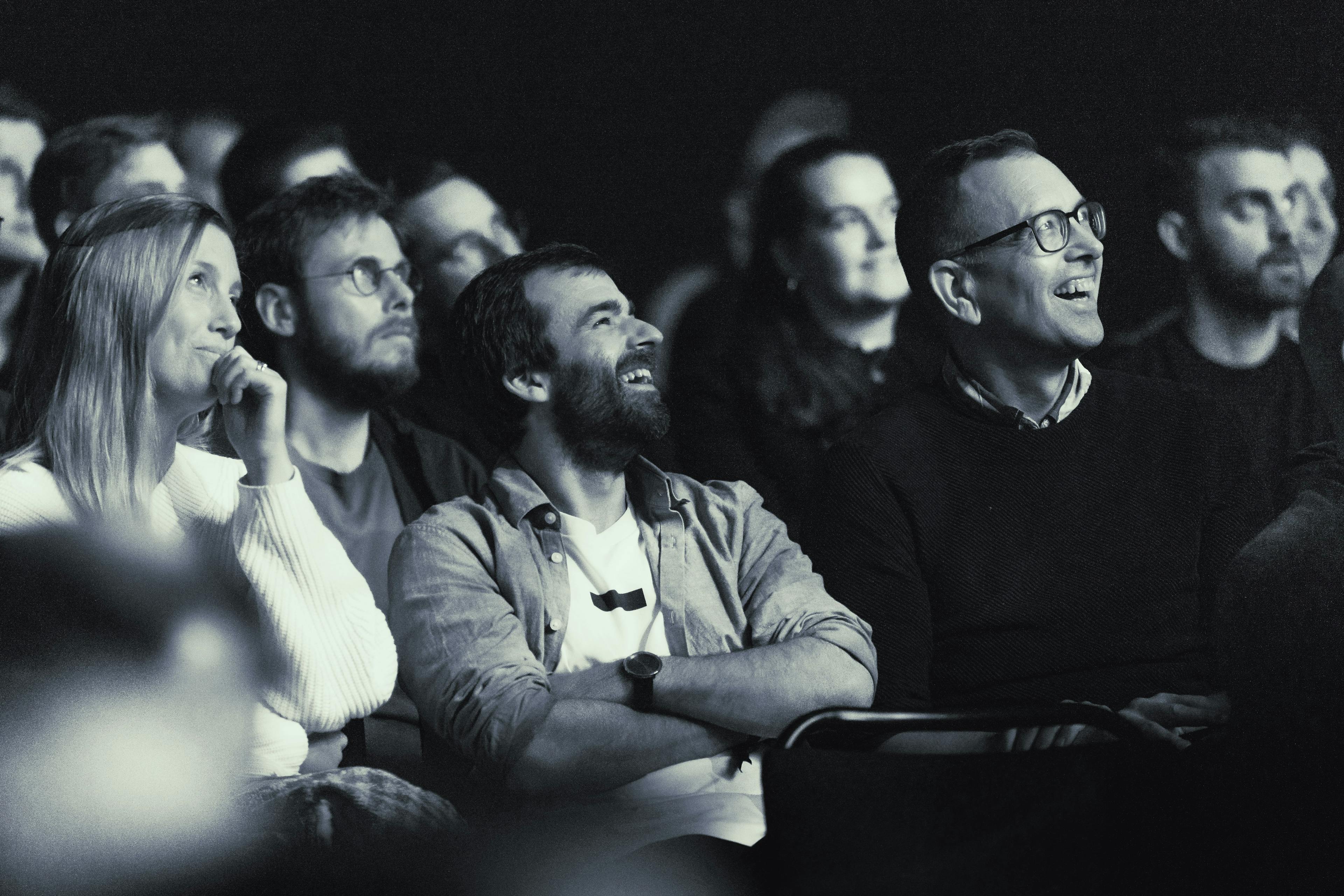 An audience listening to a presentation