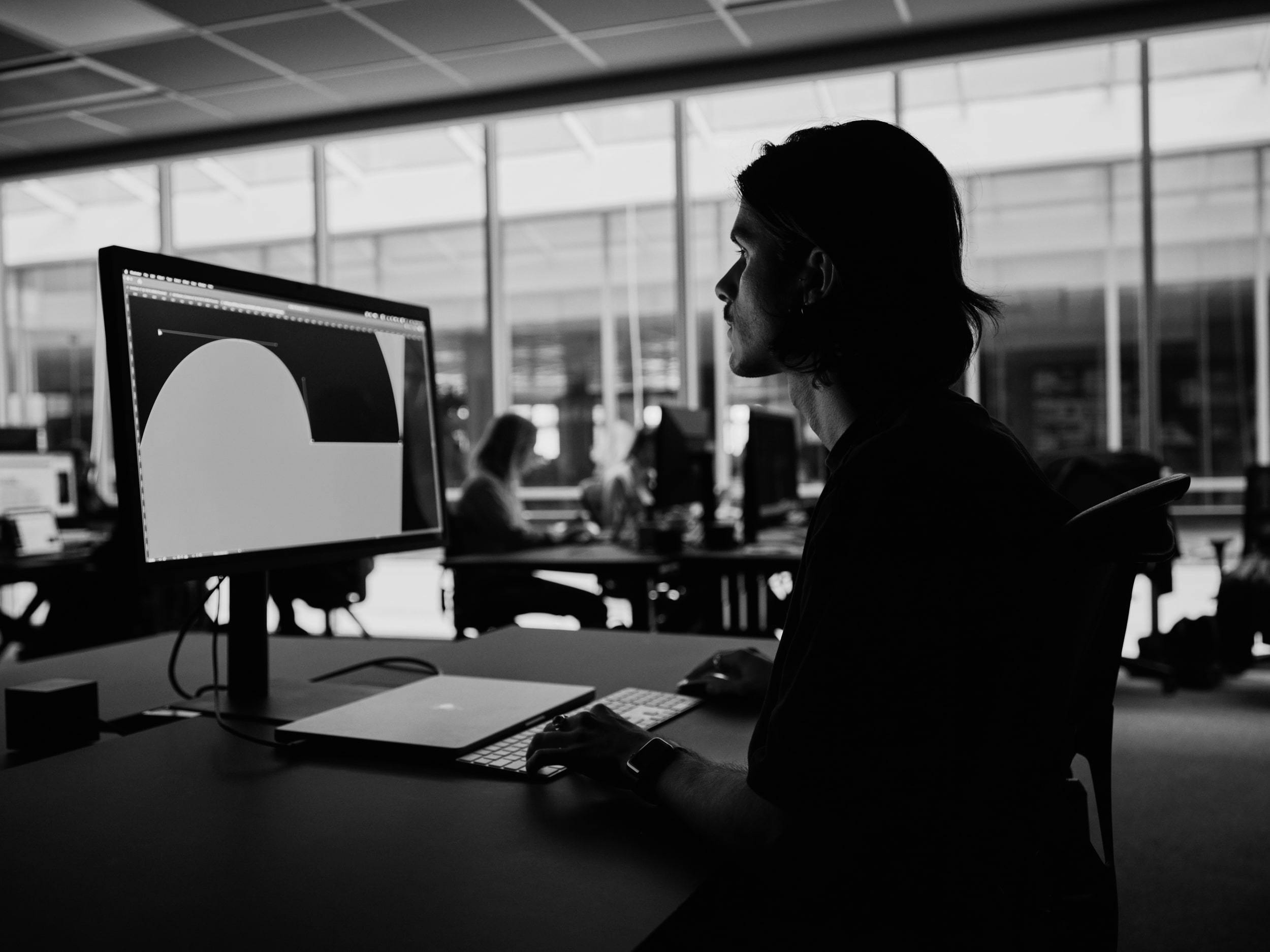 Two people in an office looking at a screen