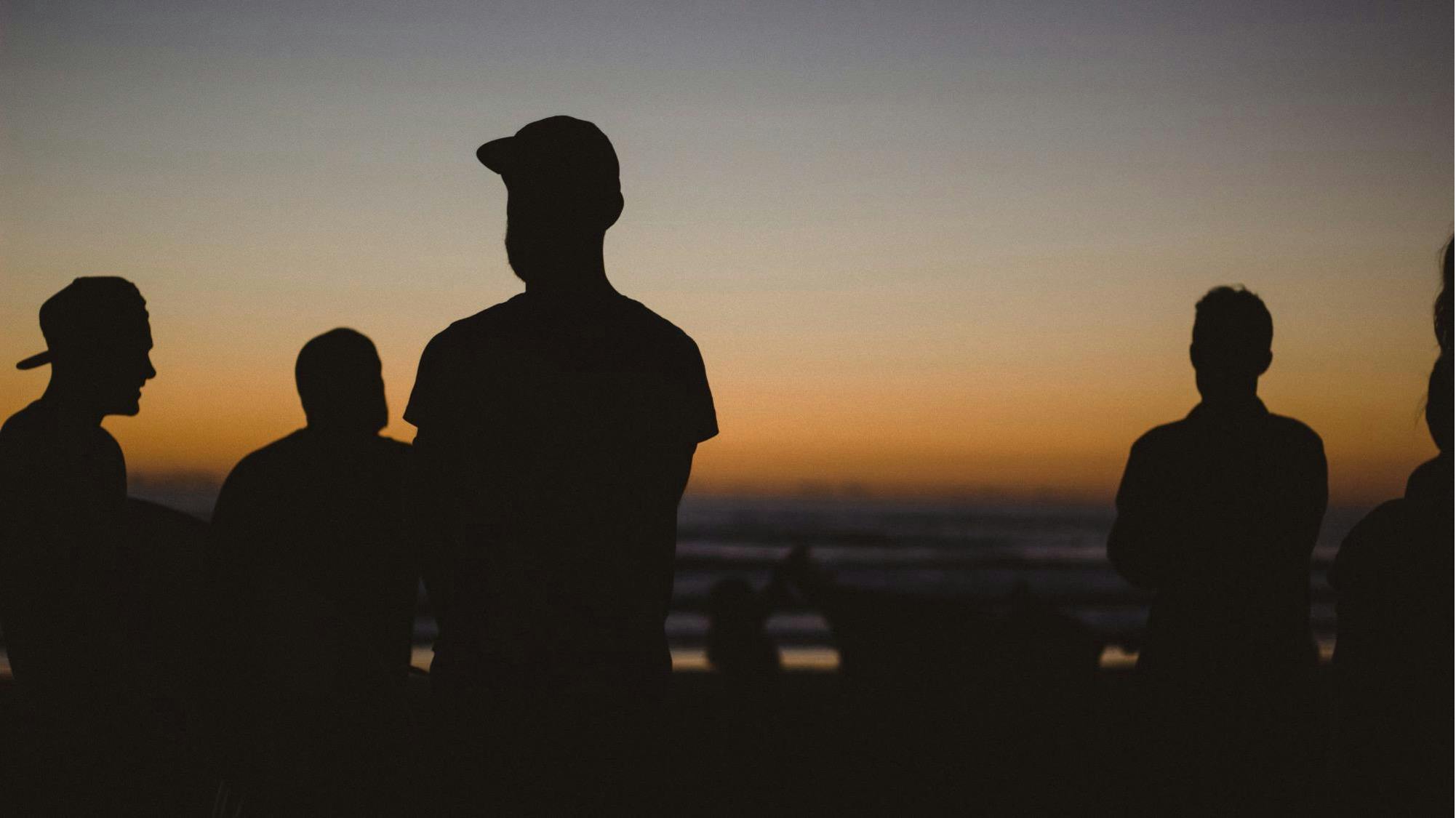 People standing in a sunset